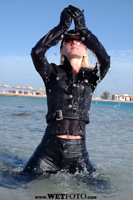 wet girl wet hair get wet black shirt leather pants baseball cap high heels fully soaked sea