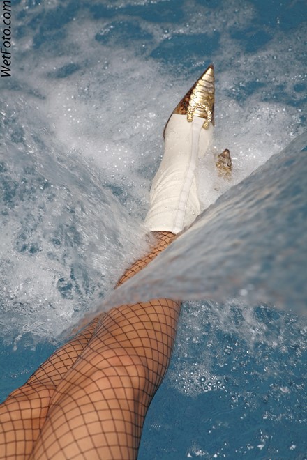 wet girl get wet fully clothed jacket shorts stockings sexy top boots poo