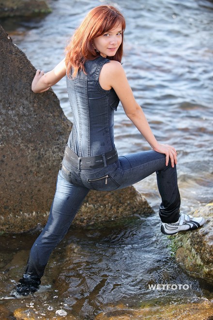 wet girl get wet wet hair fully clothed denim jumpsuit sneakers sea