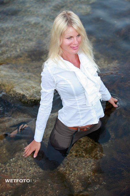 wet woman get wet fully clothed blouse leggings shoes sea