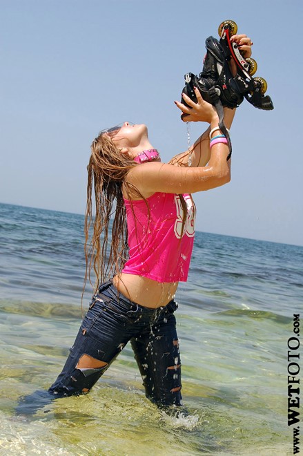 wet girl get wet wet hair fully clothed jeans t-shirt roller-skates sea