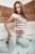 wet girl wet hair get wet short t-shirt skinny jeans high heels fully soaked bath