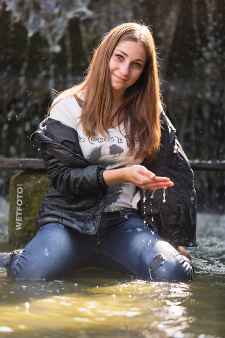 wet girl wet hair get wet sweater jacket tight jeans leather boots waterfall