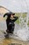wet girl get wet wet hair fully clothed jacket jeans baseball cap golf gloves leather boots river