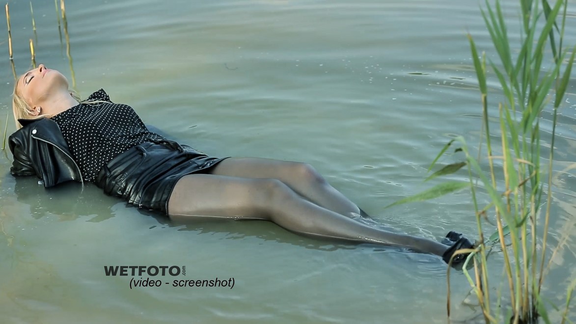 wet girl soaked get wet swimming fully clothed tights leather jacket skirt high heels lake