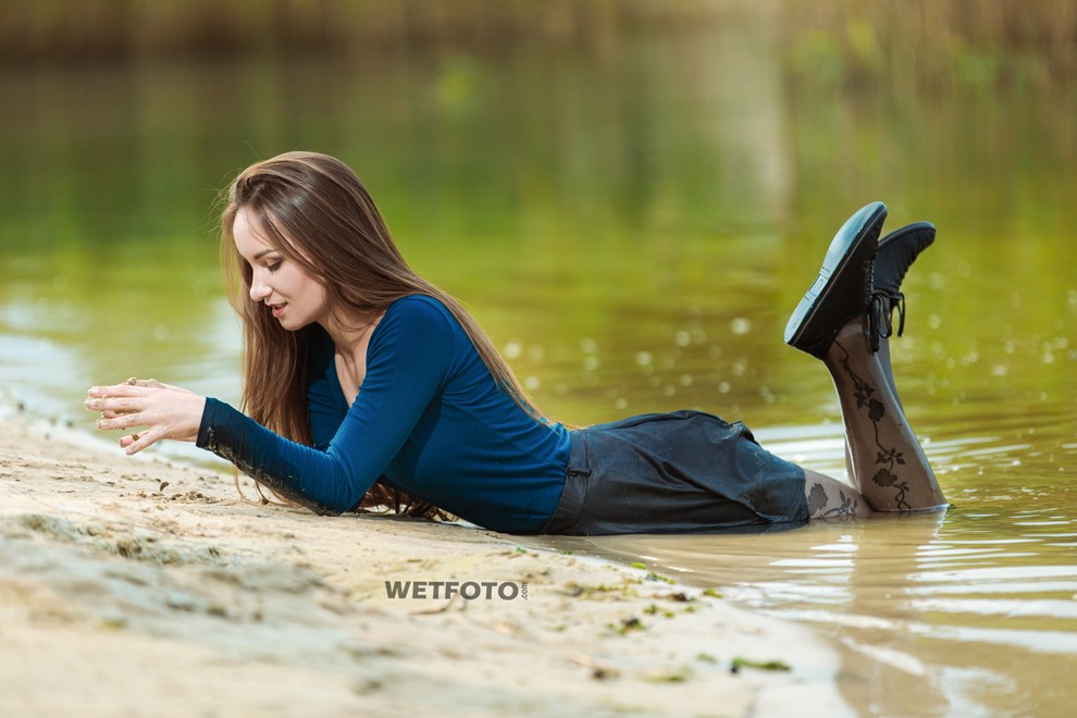 wet girl woman wet hair get wet soaked swim fully clothed skirt leather stockings blouse sneakers lake water