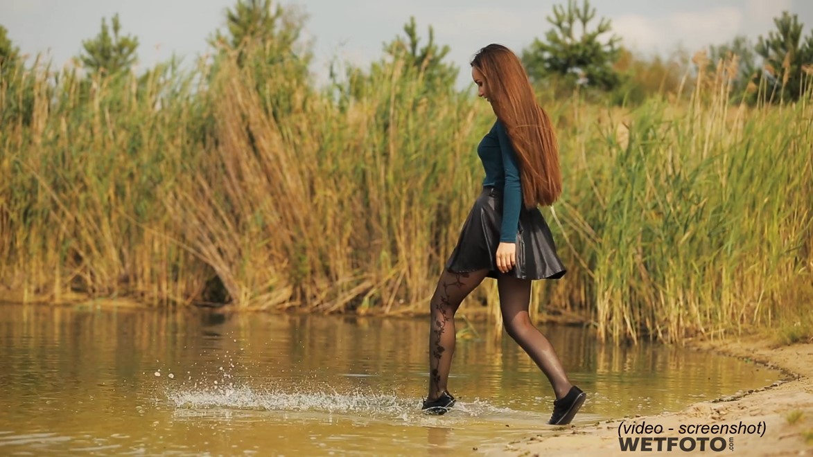 wet girl woman wet hair get wet soaked swim fully clothed skirt leather stockings blouse sneakers lake water