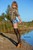 woman fully clothed wet hair shirt denim shorts stockings shoes high heels lake