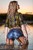 woman fully clothed wet hair shirt denim shorts stockings shoes high heels lake