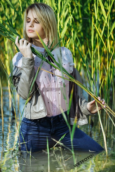 blonde wet girl swim fully clohed wet hair blouse skinny jeans jacket high heels lake