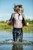 blonde wet girl swim fully clohed wet hair blouse skinny jeans jacket high heels lake