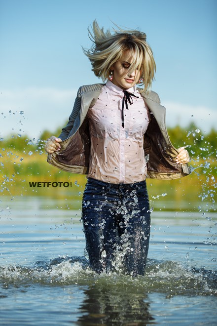 blonde wet girl swim fully clohed wet hair blouse skinny jeans jacket high heels lake
