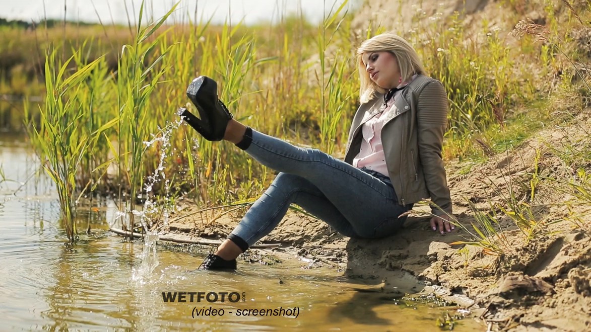 blonde wet girl swim fully clohed wet hair blouse skinny jeans jacket high heels lake