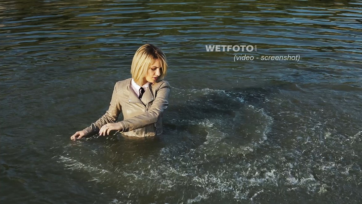blonde wet girl swim fully clohed wet hair blouse skinny jeans jacket high heels lake