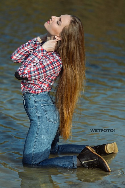 wetlook long haired girl swims posing water wet clothes on high waisted jeans shirt pantyhose wetfoto