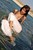 wet woman get wet wet hair fully clothed blouse pants sandals heels sea