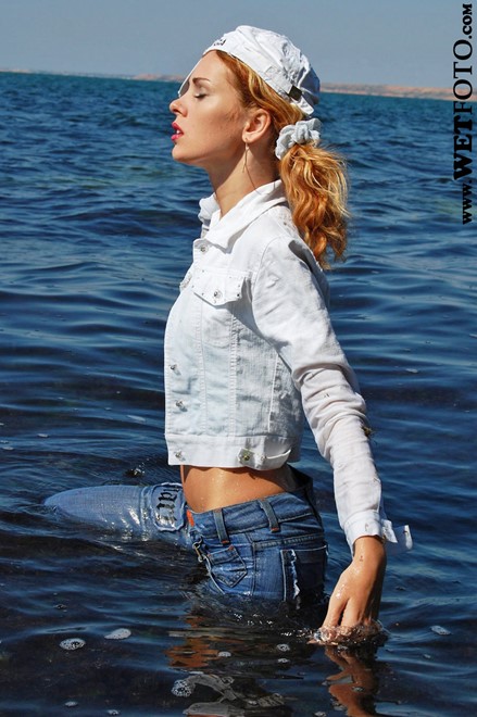 wet girl get wet wet hair fully clothed jacket jeans top baseball cap shoes sea