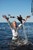 wet girl get wet wet hair fully clothed jacket jeans top baseball cap shoes sea