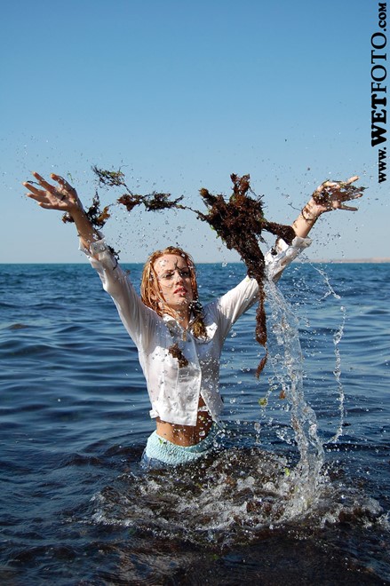 wet girl get wet wet hair fully clothed jacket jeans top baseball cap shoes sea