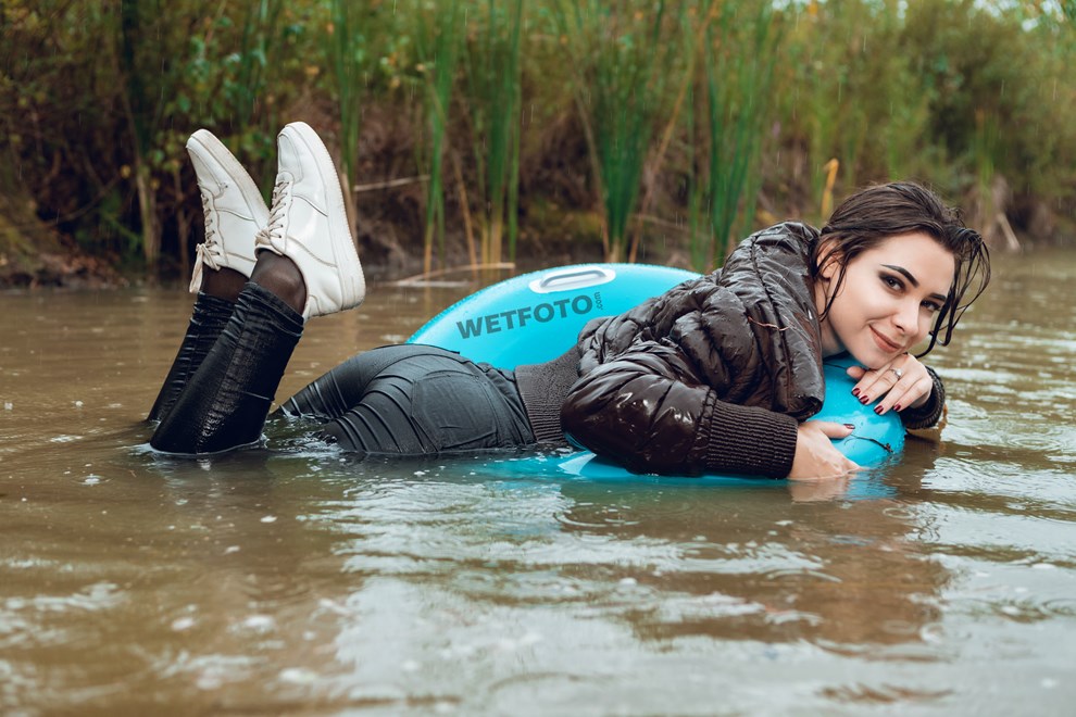 wetfoto wetlook young girl fully clothed swims under rain