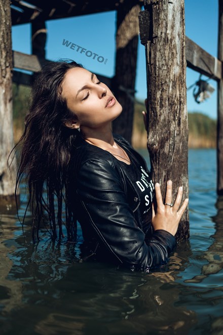 wetfoto completely wet fullydressed brunette walks on water