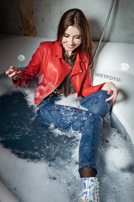 wetfoto fully dressed girl lies water bathroom