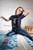 wetfoto fully dressed girl skinny jeans swims in the pool