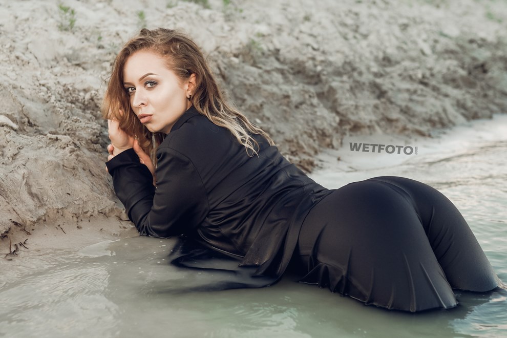 girl swims in lake business suit nylons