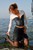 wet woman get wet wet hair fully clothed blouse skirt stockings high heels sea