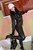 wet girl get wet wet hair fully clothed jacket leggings jackboots leather hat gloves shirt bra bath